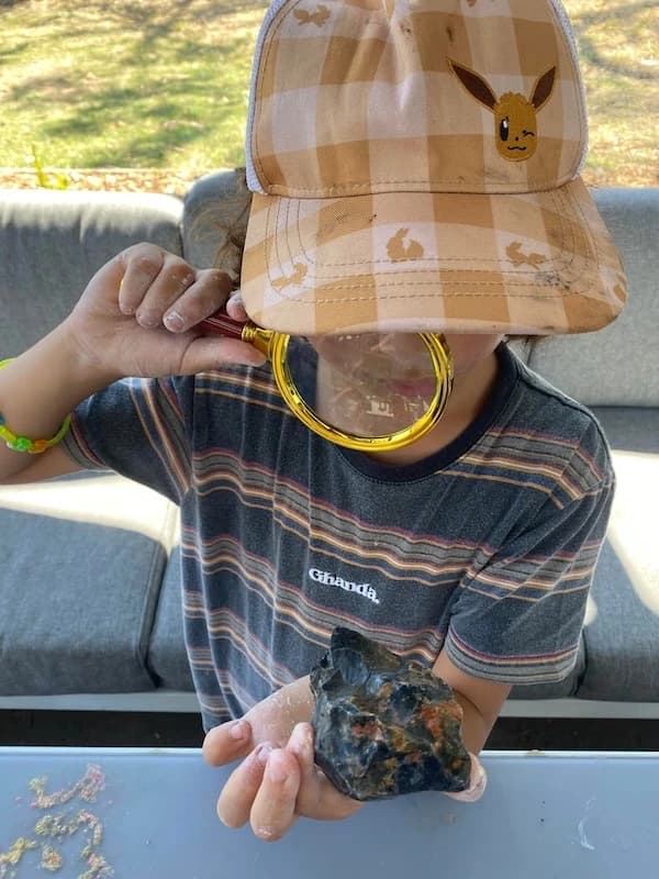 Boy looking at a rock