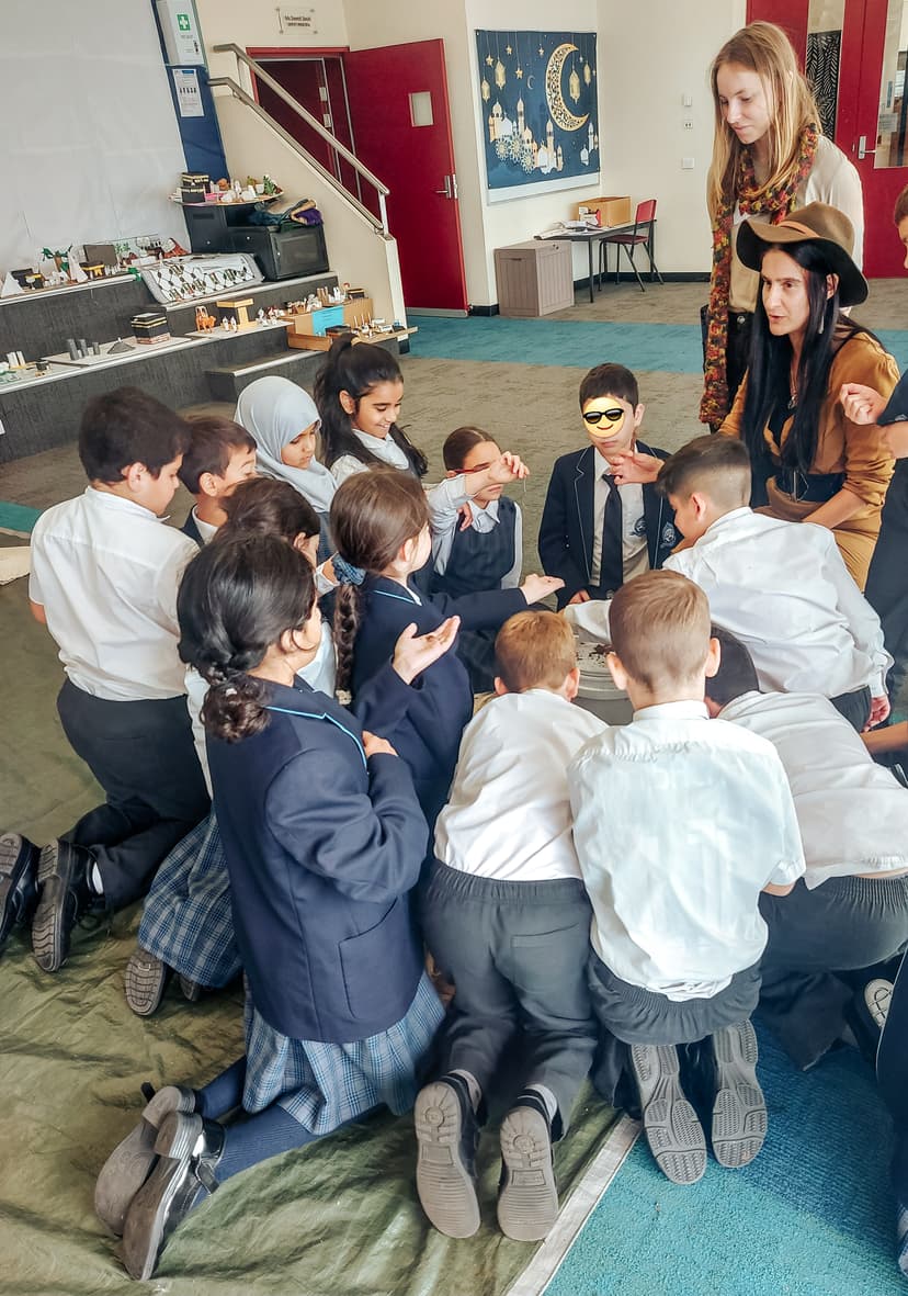 Children examining soil samples under microscope